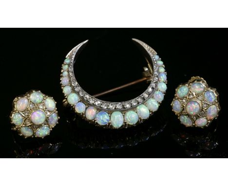 A late Victorian opal and diamond closed crescent brooch,with an outer row of oval and circular cabochon opals, all claw set 