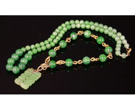 A jade bead gold bracelet with a carved jade pendant,composed of 7.5mm diameter jade beads, on gold wire, all joined by jump 