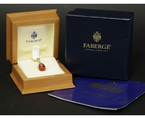 A cased 18ct gold, limited edition, contemporary egg pendant,by Fabergé.  The egg, with a gold leaf to red guilloché enamel g