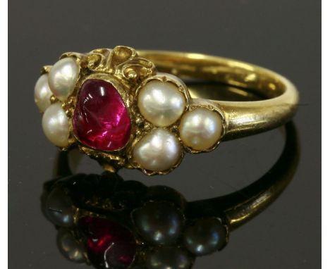 A Victorian ruby and split pearl ring,with a freeform cabochon ruby, rub set to the centre.  A trefoil cluster of split pearl