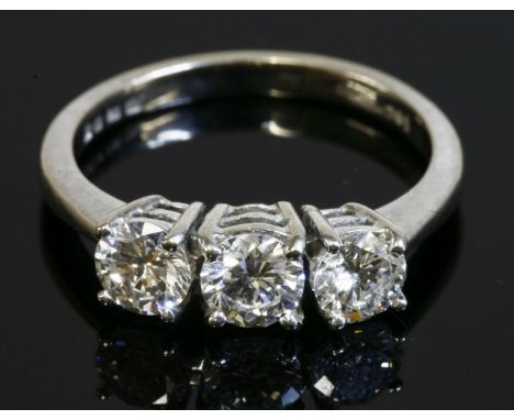 An 18ct white gold three stone diamond ring,with three brilliant cut diamonds, with an estimated total diamond weight of 0.94