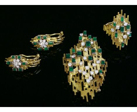 An emerald and diamond brooch/pendant, ring and earrings suite, c.1970,in the style of Andrew Grima.  The kite-shaped brooch/