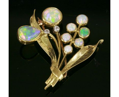 An opal and diamond gold spray brooch, c.1950,with graduated semi-black and white opals, all rub set in plain collets forming