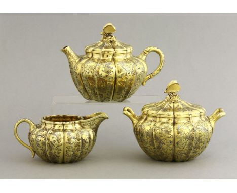 A George IV/Victorian silver gilt three-piece tea set,the teapot and two-handled sugar bowl and cover by Philip Rundell, Lond