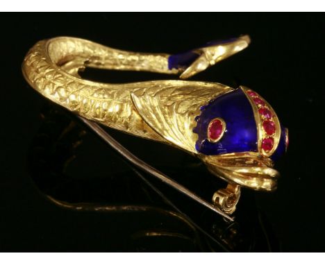 An Italian gold, ruby and enamel dolphin or fish brooch,by Gucci.  Serpentine shaped body with engraved and textured scales, 