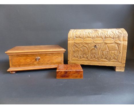 A carved wooden casket, a marquetry and parquetry box and a small burr walnut trinket box 