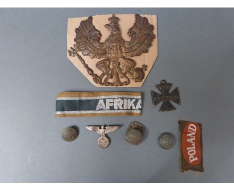 A collection of WWI and WWII German insignia including helmet badge 