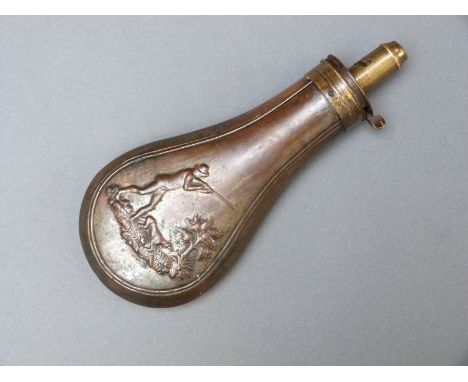 Copper and brass powder flask with embossed decoration of a man shooting with his dog, marked to the top 'patent', 19cm long.