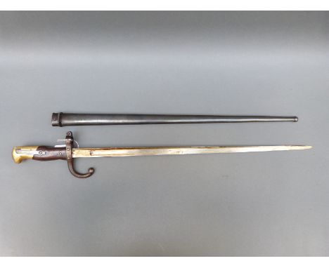 A French 1874 pattern bayonet marked Mre d'Armes de Chat, in scabbard