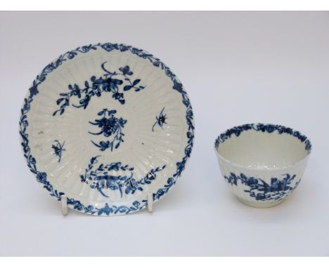 A first period Worcester tea bowl and saucer with marks to base