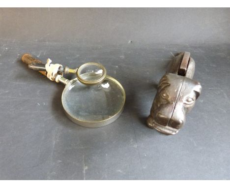 A nutcracker in the form of a dog, together with two vintage magnifiers