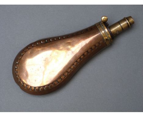 Copper and brass powder flask with embossed rivet style decoration, 19cm long. 