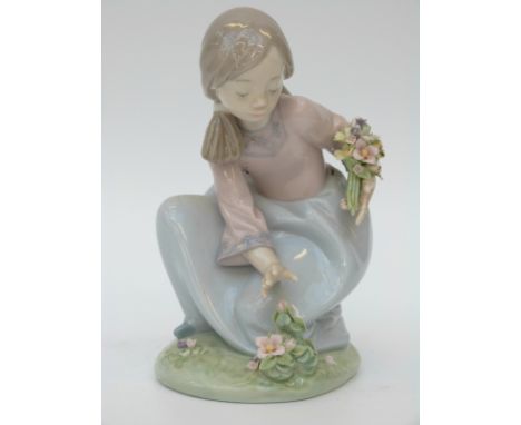 Lladro figurine of a girl with a basket of flowers