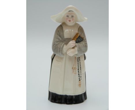 Royal Worcester candle snuffer in the form of a nun or abbess with puce mark. 