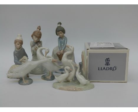 Eight Lladro and Nao figures including a child with a lamb