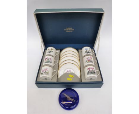 A Royal Worcester boxed coffee set with botanical decoration and a Bristol Blue Concorde paperweight 