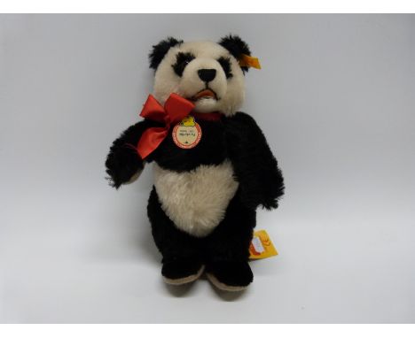 Steiff 1938 replica Panda teddy bear with jointed limbs, button and label to ear, pendant and label, 28cm tall