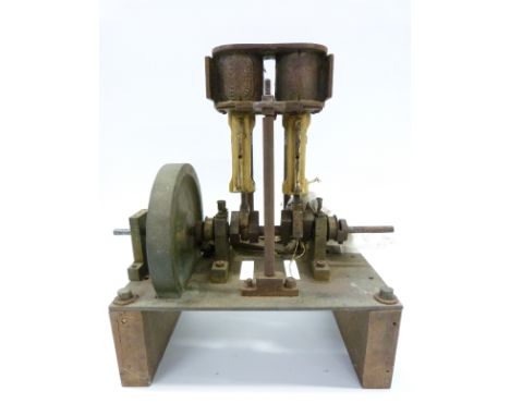 A part finished twin cylinder live steam engine, the cylinder marked 'Stevens Model Dockyard' with solid flywheel on metal ba