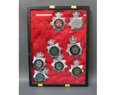 A display of eight police helmet badges UKAEA Constabulary, Lincolnshire, Royal Parks etc