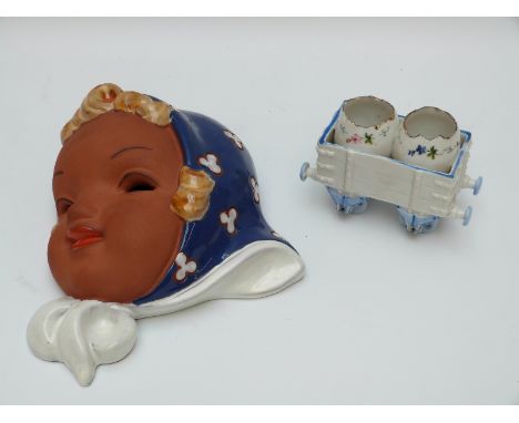 Goldscheider style face mask and a continental cruet in the form of a railway carriage 