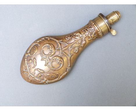 G & J.W Hawksley copper and brass powder flask with ornate embossed scrolling leaf and berry decoration, 21cm long. 