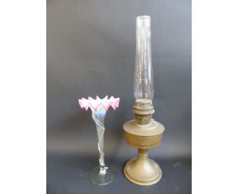 A brass oil lamp together with a glass bud vase with fluted vaseline-type decoration, 31cm tall