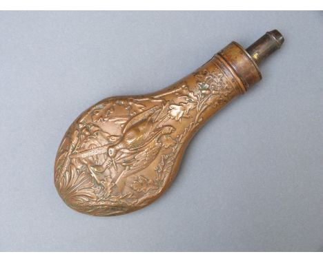 Copper and brass powder flask with heavily embossed decoration of game birds to one side and leaves and berries to the revers