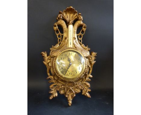 An ornate clock barometer 