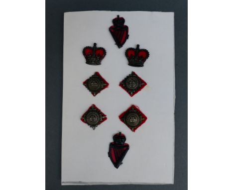 A set of Irish police metal badges and insignia with pierced harp and shamrock decoration