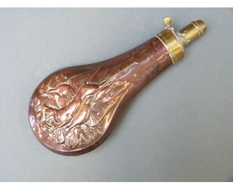 A copper and brass powder flask with embossed decoration of hares and pheasants, 19.5cm long.  