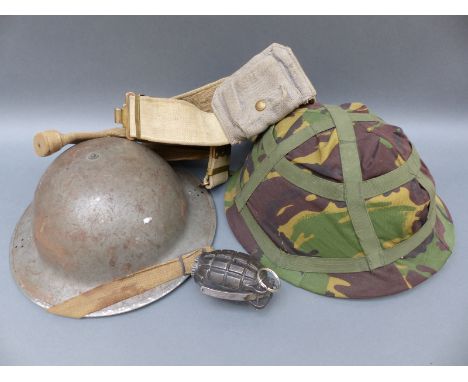 A practice hand grenade marked RBD together with two army helmets, one WWII example marked F&L 1940 MS and a canvas holster o