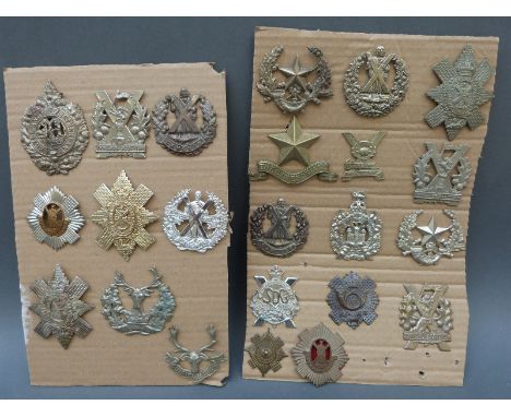 A collection of 25 Scottish regimental badges including Black Watch, Gordon Highlanders, Highland Light Infantry, Tyneside Sc
