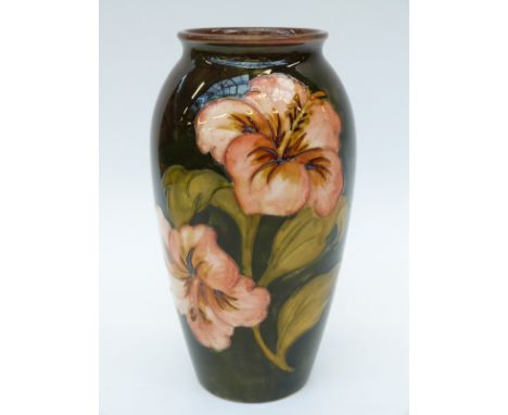 Moorcroft vase in Hibiscus pattern by Walter Moorcroft with light flambe glaze (18cm tall)