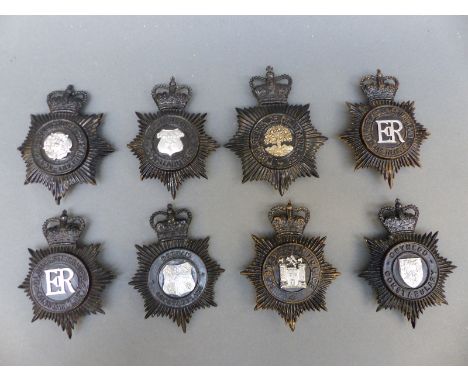 Eight police helmet badges including Durham, Gloucestershire Constabulary, Cumberland and Westmorland, Worcestershire, Gwyned