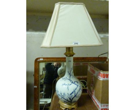 An enamelled ceramic lamp with prunus decoration and sqaure shade (H78cm)