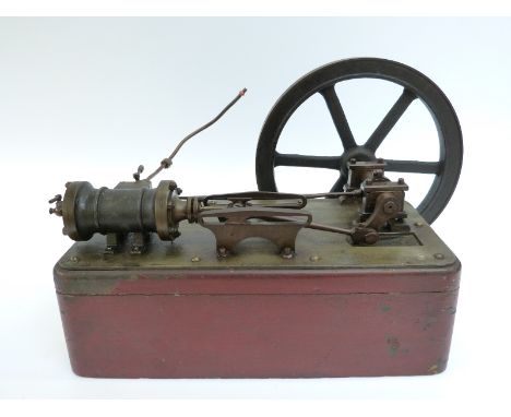 A late 19th/early 20thC horizontal live steam stationary steam engine mounted on wooden base with crosshead ribbed cylinder a