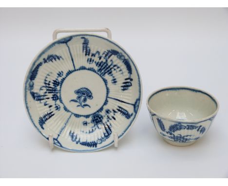 A first period Worcester tea bowl and saucer with open crescent mark to base
