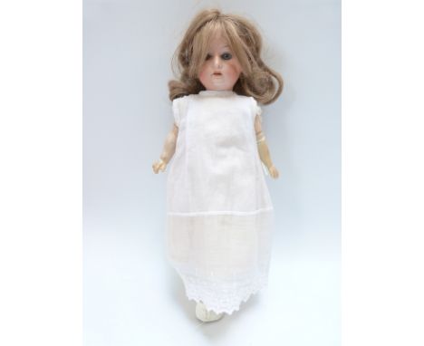 Armand Marseille bisque headed doll with open mouth, fixed blue eyes, long brown hair and articulated limbs, marked to the ba