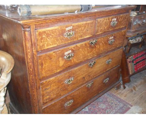 Georgian oak chest of drawers on ogee bracket feet having three dummy drawers and lift-up top above two graduated long drawer