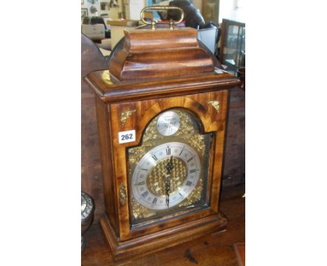 20th c. arch-topped bracket clock with brass dial & silvered chapter ring in walnut case