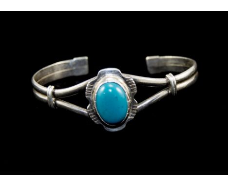 A Vintage Silver Bangle, Set To The Centre with a Large Cabochon Cut Blue / Green Stone. Not Marked But Tests Silver. 