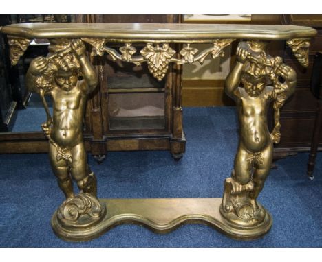 Italian Rococo Style Gilt Wood And Composite Console Table, Shaped Top With Figural Putti And Grapevine Supports Standing On 