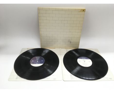 A first UK pressing of Pink Floyd 'The Wall' SHDW411. Vinyl is NM. Sleeve is slightly yellowed and has a mark to the front, n