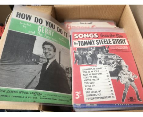 A box of vintage sheet music.