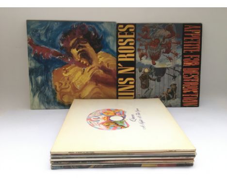 Twelve LPs by various artists including Jimi Hendrix, Guns n Roses, Queen and others.