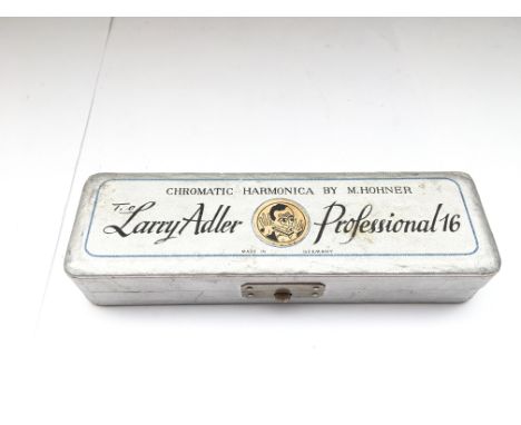 A cased Hohner 'Larry Adler' harmonica, never used and still in original wrapping. Comes with 'The right way to play' by Jame