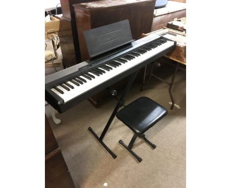 A Casio CDP100 keyboard with stand and stool (3). Comes with manual and power supply.