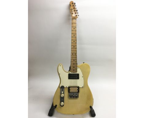 A circa 1970s left handed Fender Telecaster fitted with dual humbuckers in a butterscotch finish with a white scratchplate. S