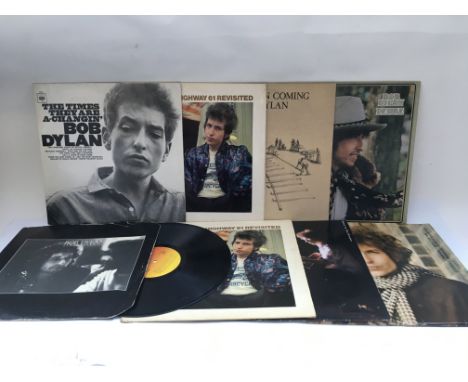 Nine Bob Dylan LPs including 'Blonde On Blonde', 'Highway 61', 'The Times They Are A Changin' and others.