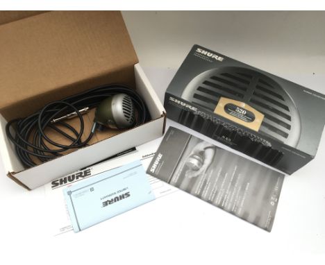 A boxed Shure 520 DX harmonica microphone.